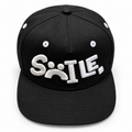 Black SMILE embroidered hat — studio front view